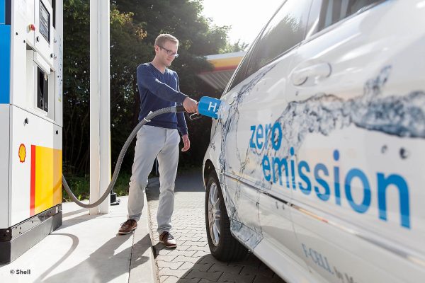 A person filling a hydrogen powered vehicle